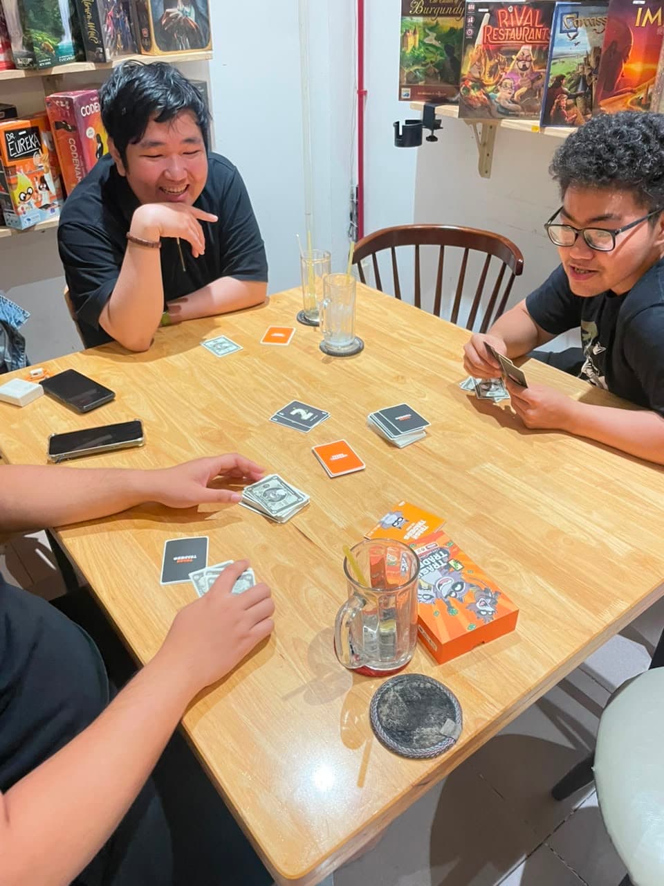 Players mid-trade at a Trash Traders table
