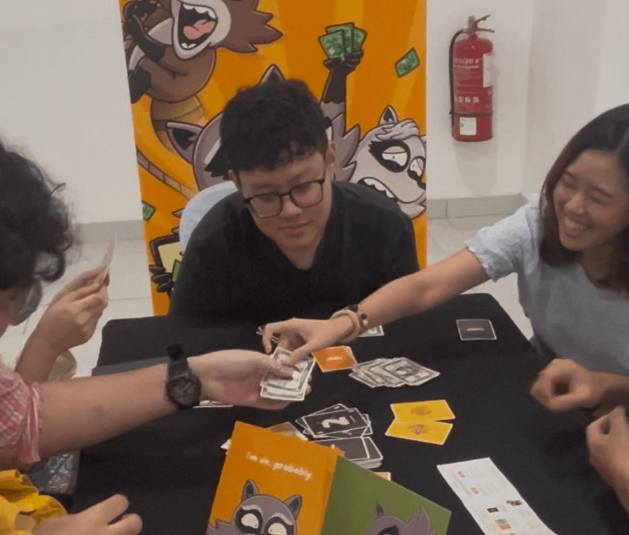 Players trading cash during a Trash Traders game